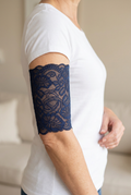Navy unlined lace PICC cover on an adult model